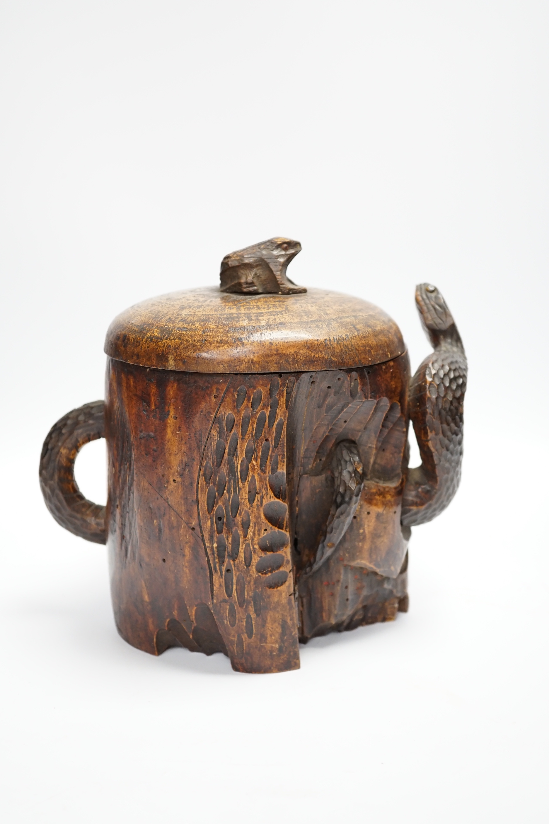 A Japanese carved wood tobacco jar in the form of a skull and snake, Meiji period, 21cm high